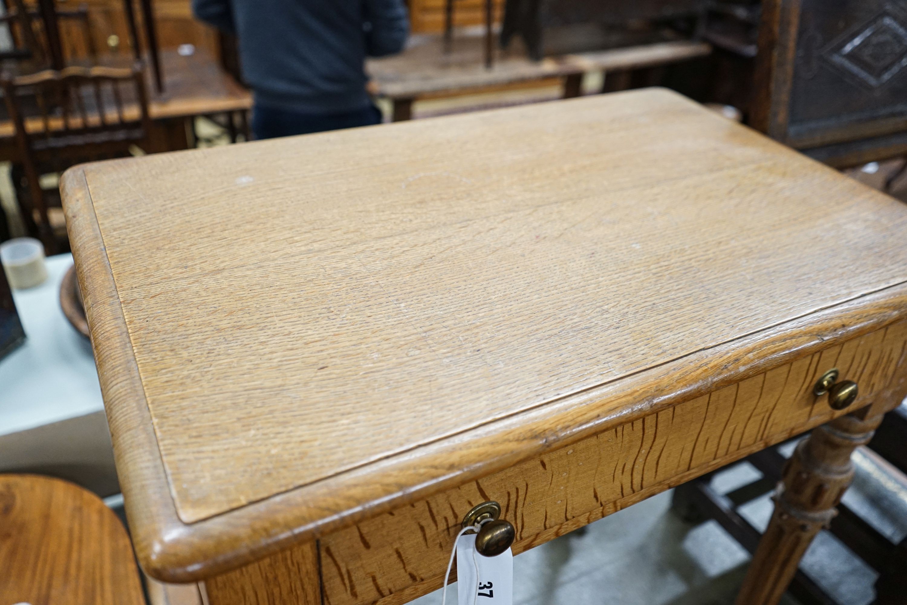 A Victorian golden oak side table, with single drawer, turned and fluted legs on brass castors, width 68cm, depth 46cm, height 73cm